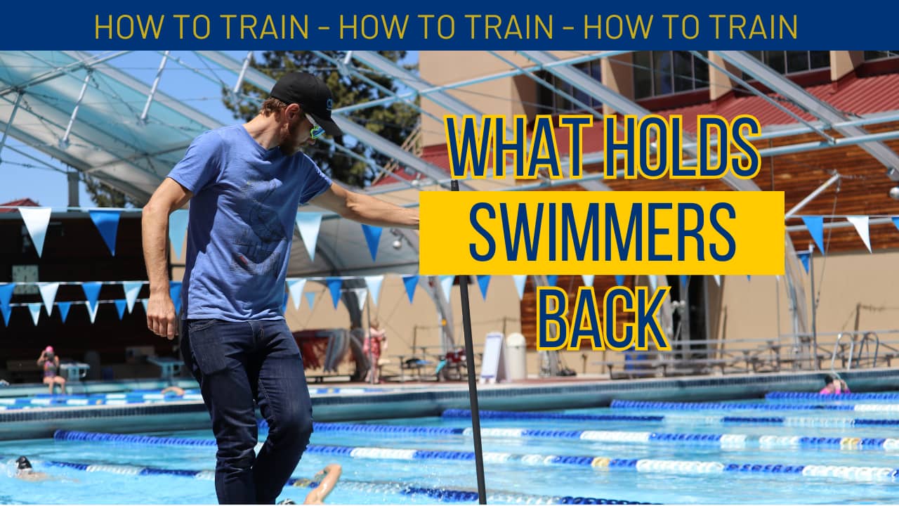 A coach performing a swim analysis with a sign that says "What Holds Swimmers Back"