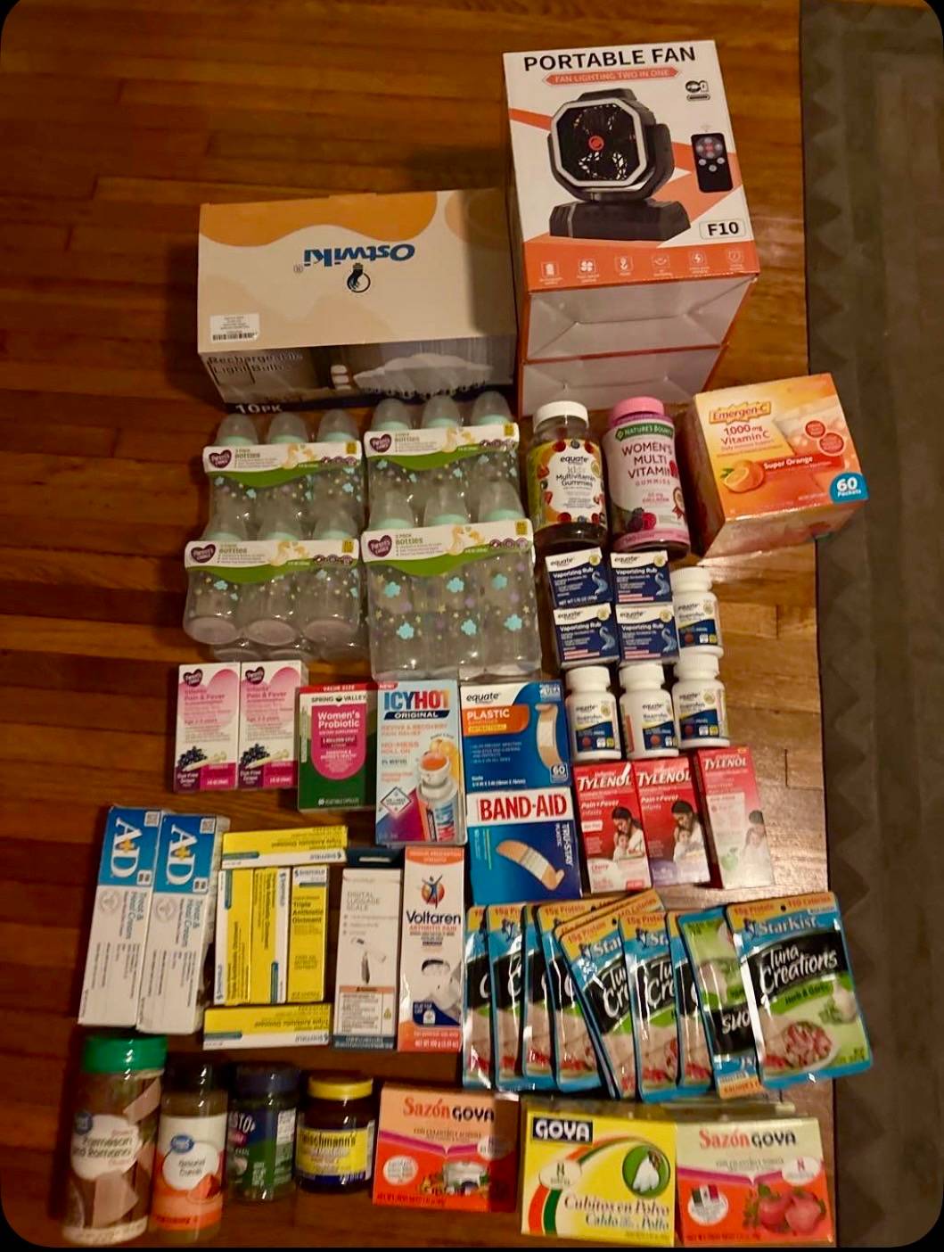 Living room floor in Nashville - 12 baby bottles, 10 rechargeable bulbs, 2 portable fans, medicine and food from 9 donors - $800 turned into $411 of supplies