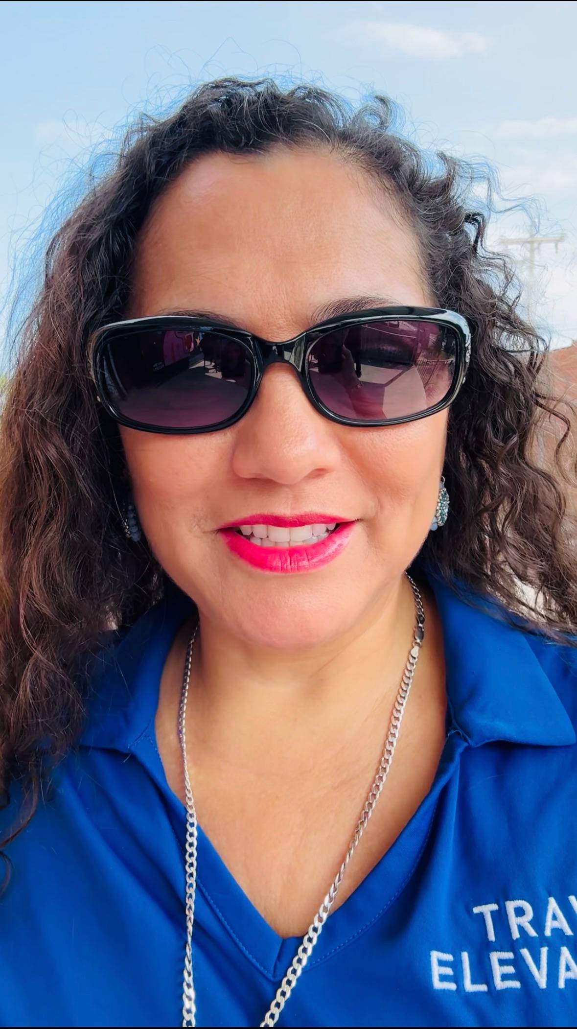 Sheyla in blue Travel Elevates shirt - 700 views video about Cuba humanitarian trip Sept 9-14
