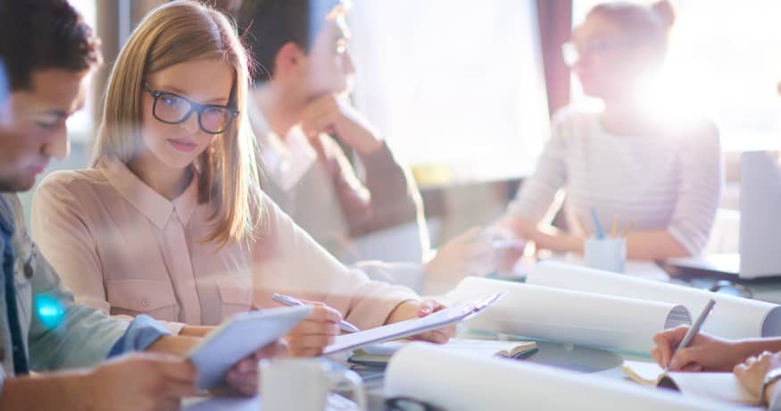 employees at table woman with pink shirt