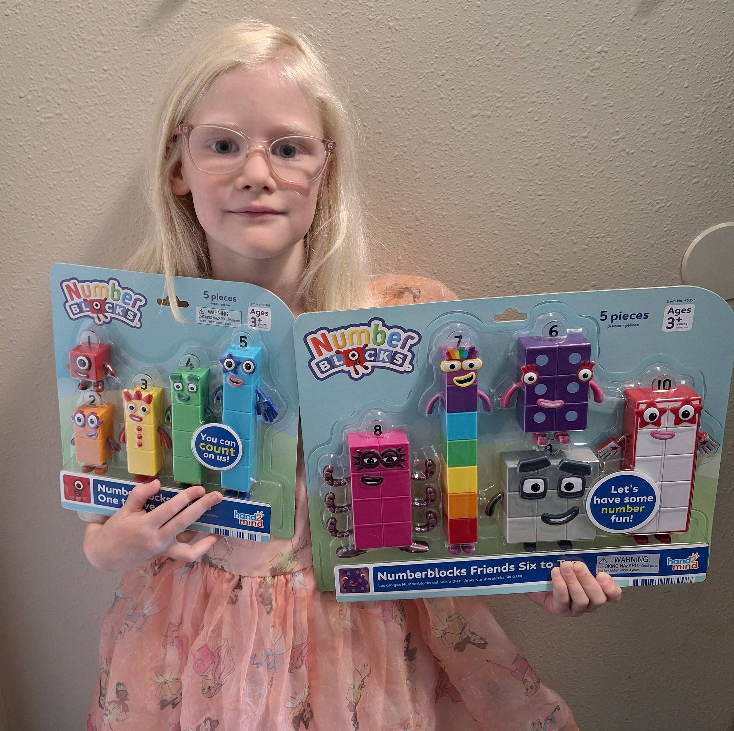 girl holding numberblocks packages