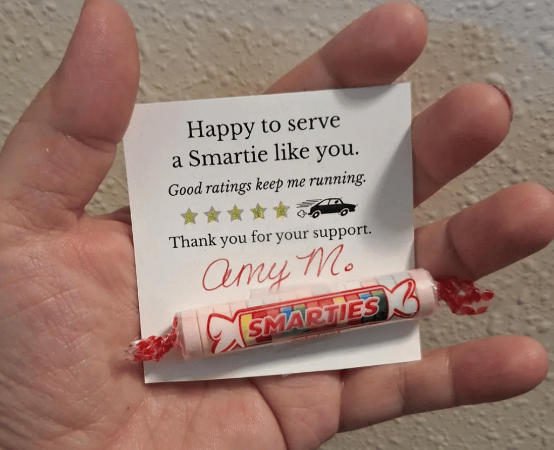 hand holding a card that says happy to serve a smartie like you good ratings keep me running than you for your support amy m candy