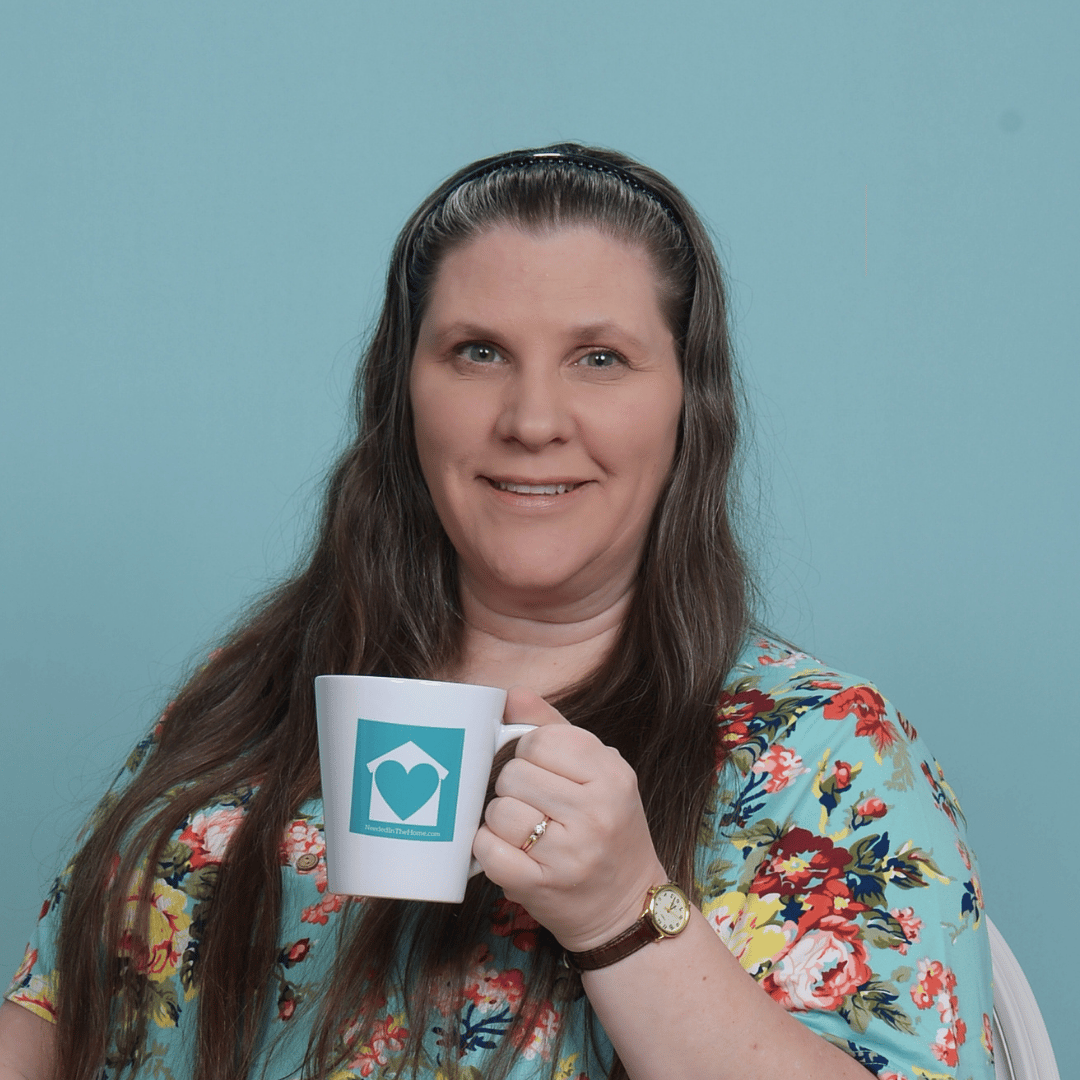amy at neededinthehome holding mug
