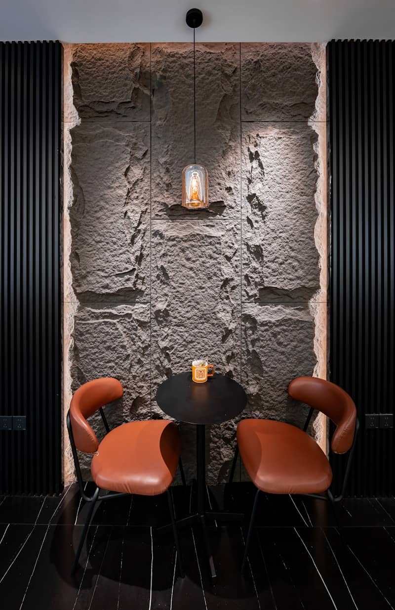 Cozy seating area with stone wall and ambient lighting.