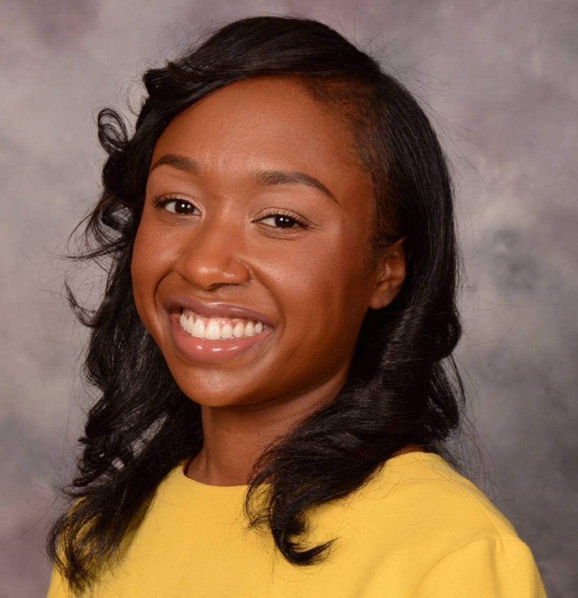 Victoria Newman, Esq., smiling in a yellow blouse