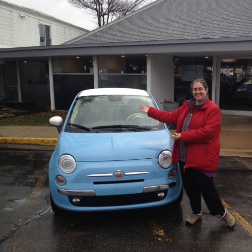Keely standing beside her 2015 sky blue Fiat, Christmas Eve 2014