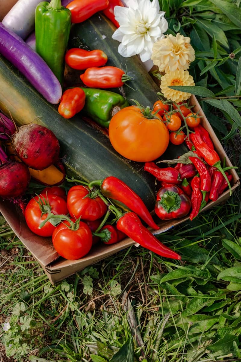 Fresh vegetables and flowers in a rustic box.