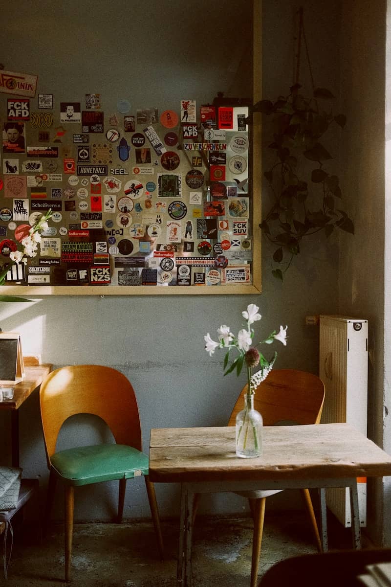 Wooden table with chairs and flower vase