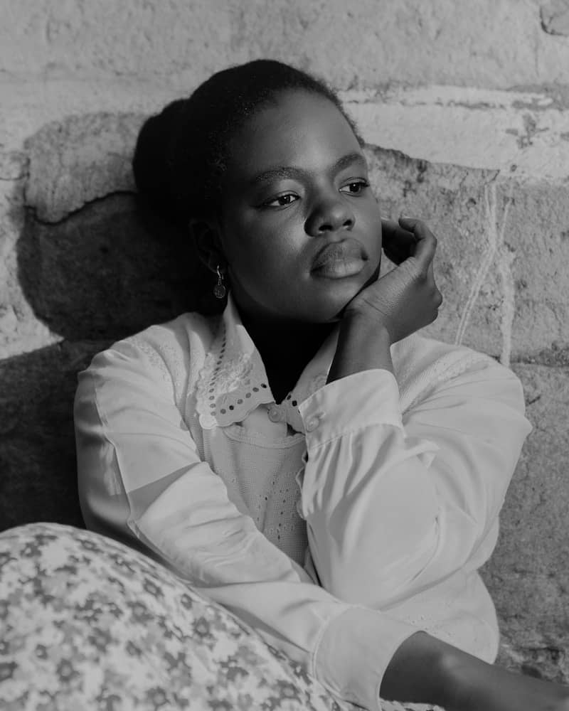 A black and white portrait of a young woman