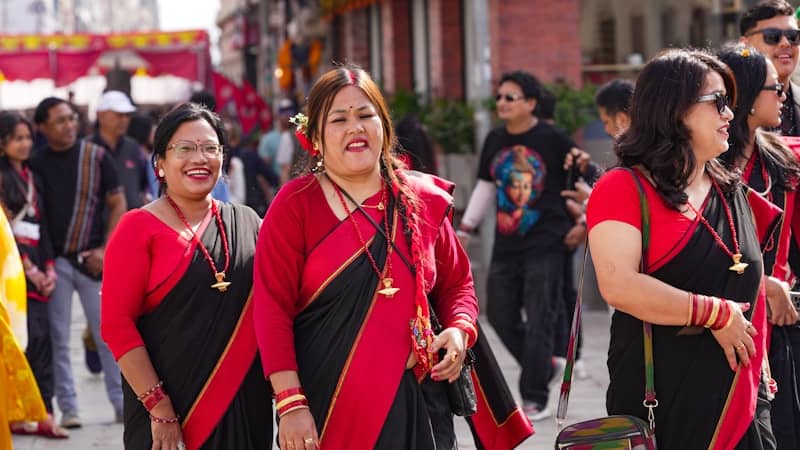 Women in traditional attire walking together outdoors.