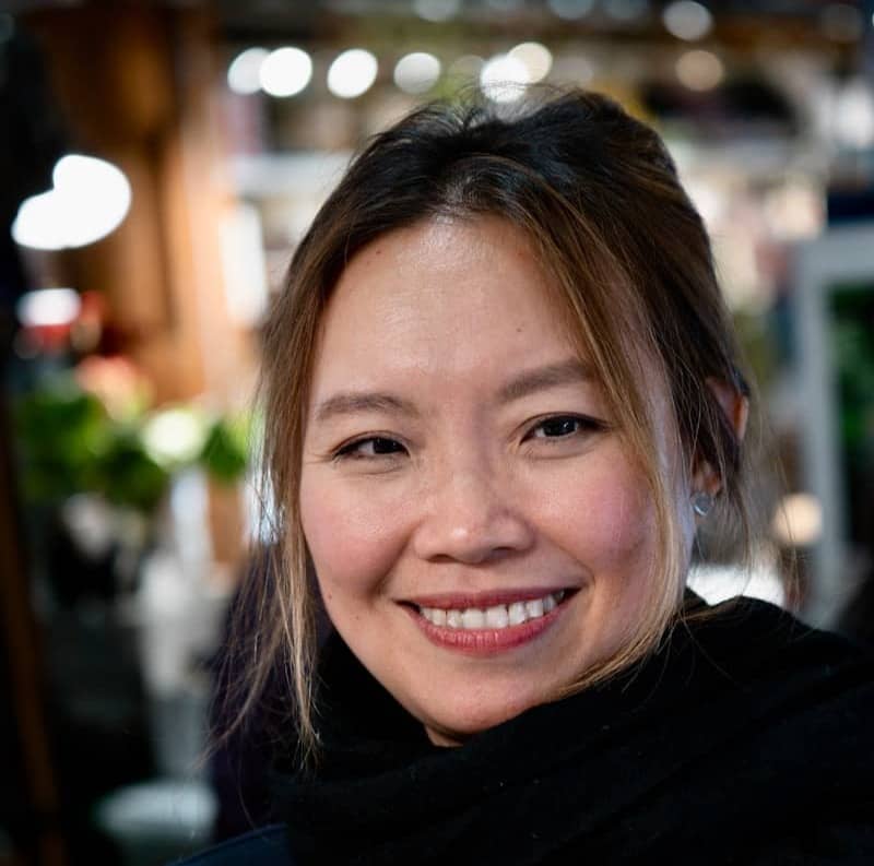 A smiling woman with a black scarf