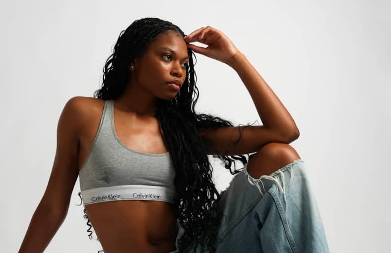 A woman sitting on the ground in jeans