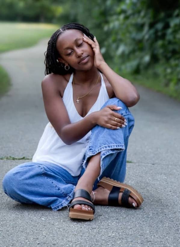 Thoughtful woman sitting on a winding path outdoors