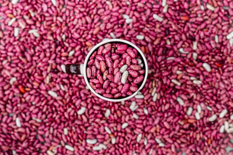 A white cup filled with pink beans