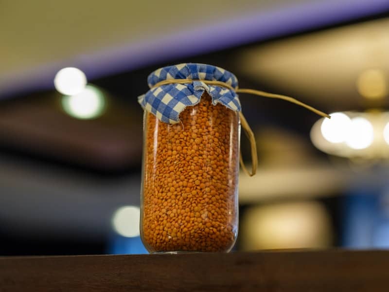 Jar of lentils with a fabric cover.