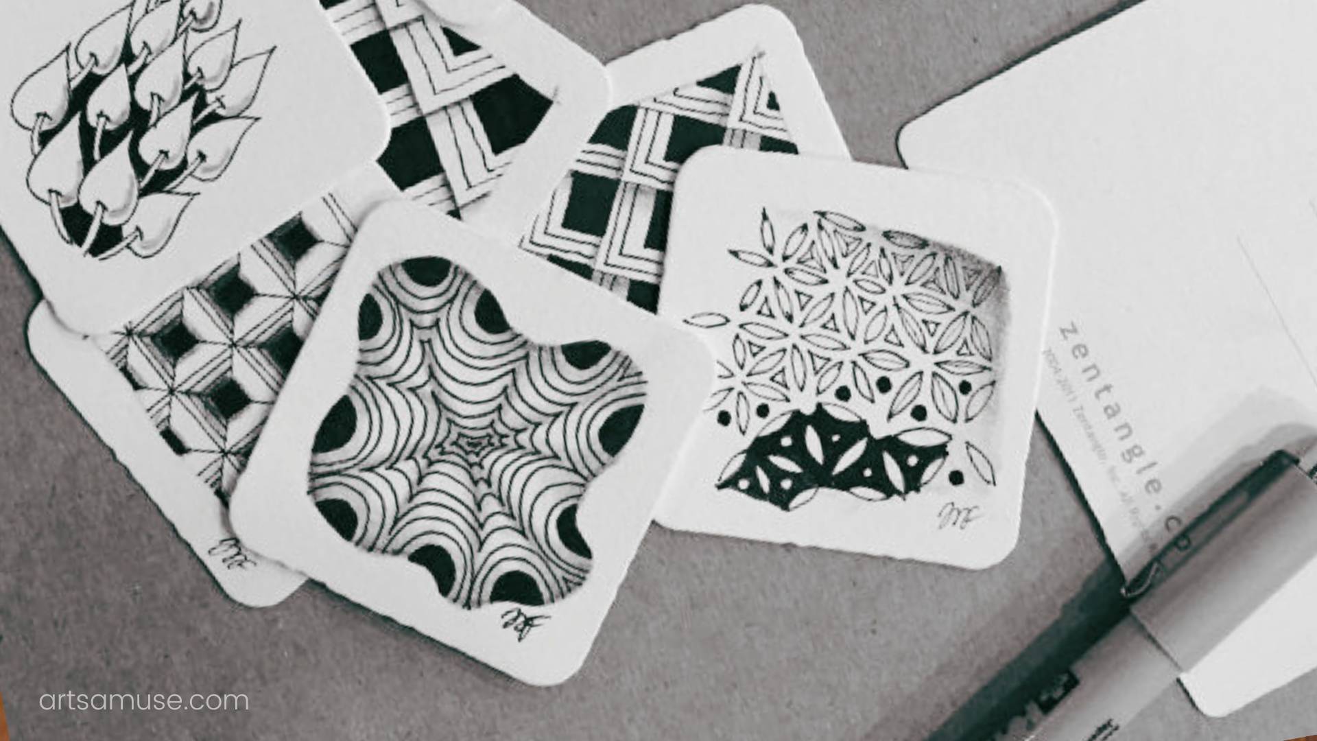 patterns drawn on white square papers