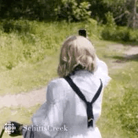 Woman holding her phone up to the air to try get signal