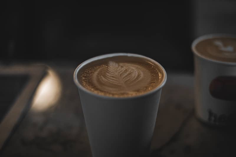 Two cups of coffee sitting on a table