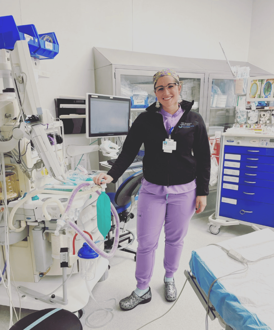 Kalli McGrievy, DNP, CRNA, smiles in her scrubs at the hospital.