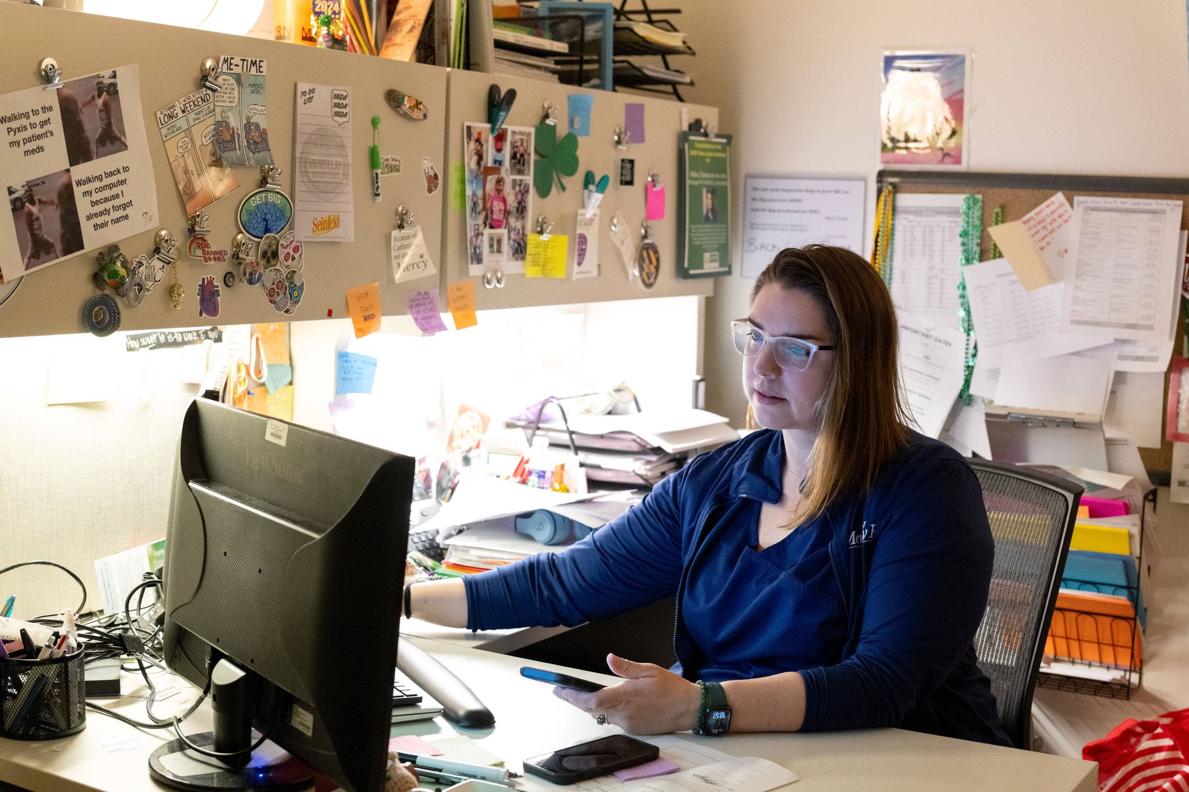 Nurse Manager Hillary Stamp is seen at her work desk.