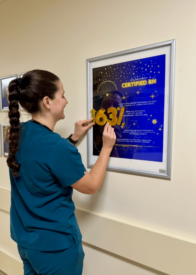 Nurse Chloe Carter hangs a poster.