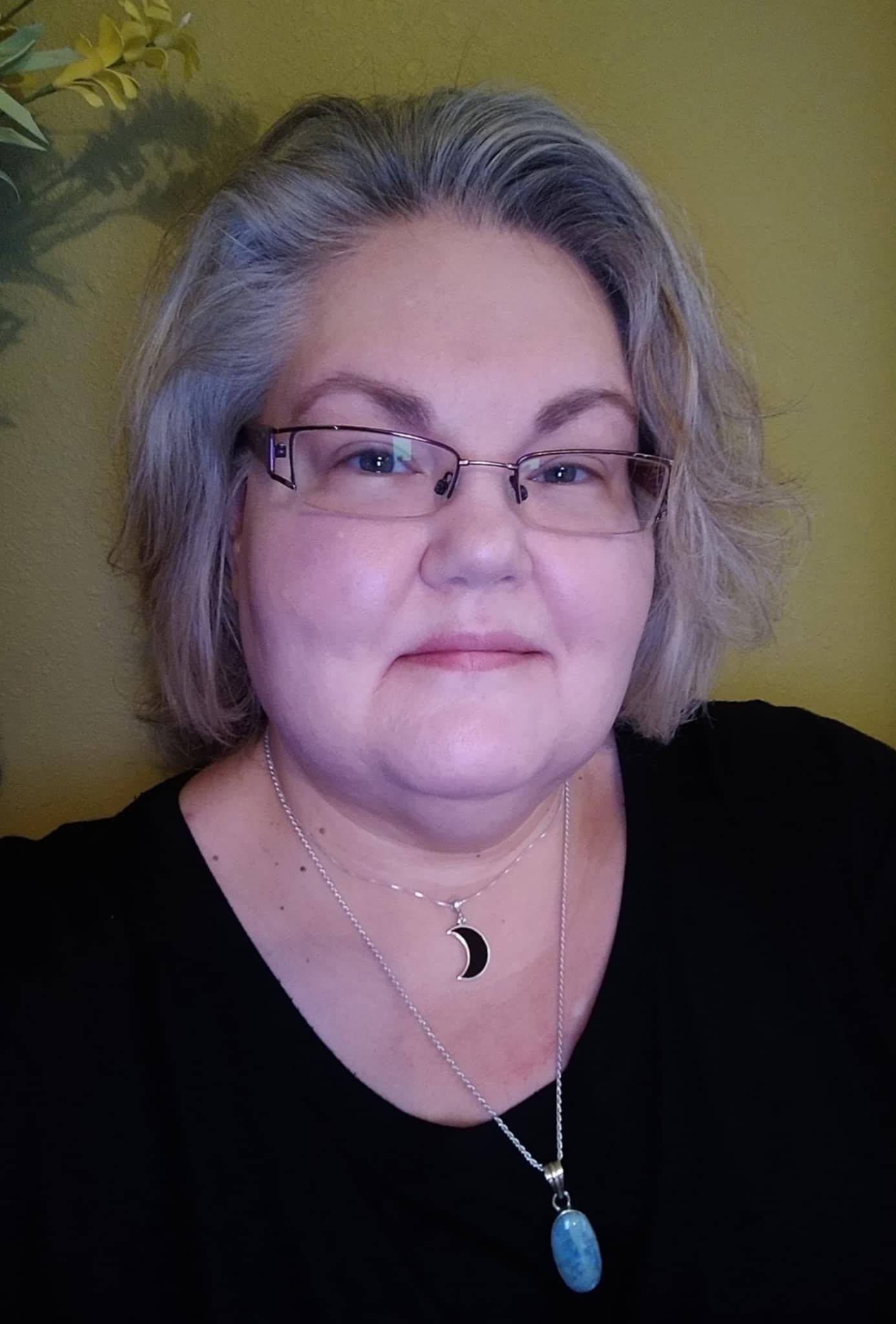 Liz, RN, is pictured smiling.