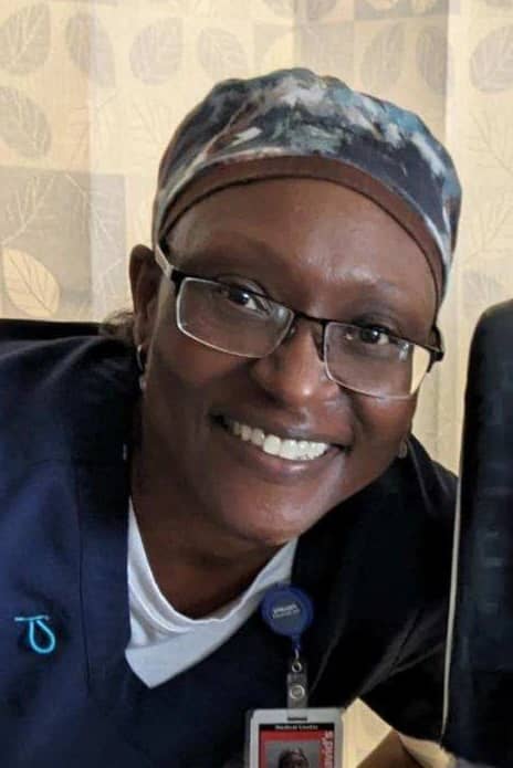 Luetwinta Breedlove, Registered Nurse, is pictured smiling in her scrubs.
