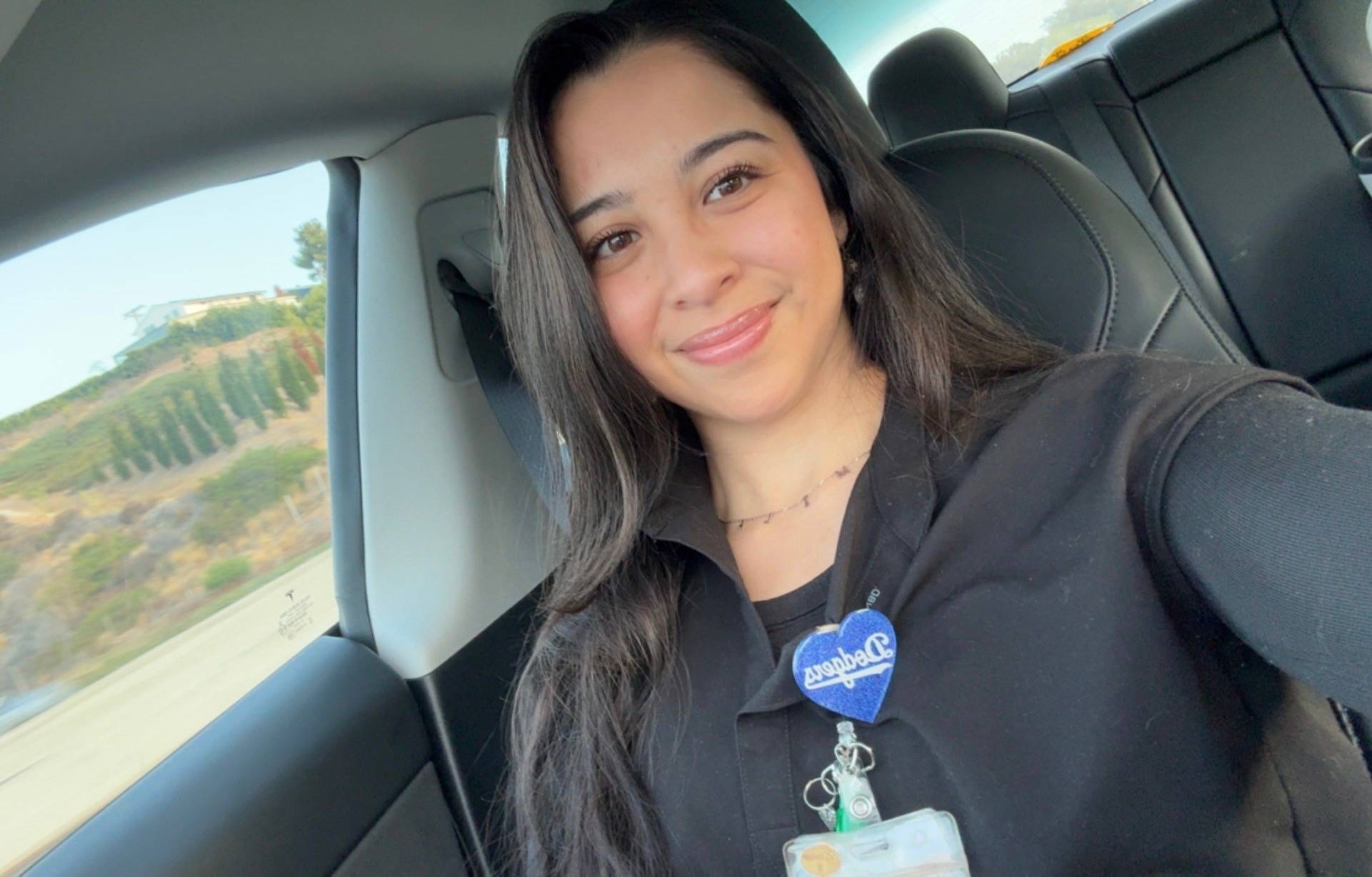 Kalani Perez, MSN, RN, FNP-S, smiling in a selfie taken in a car.