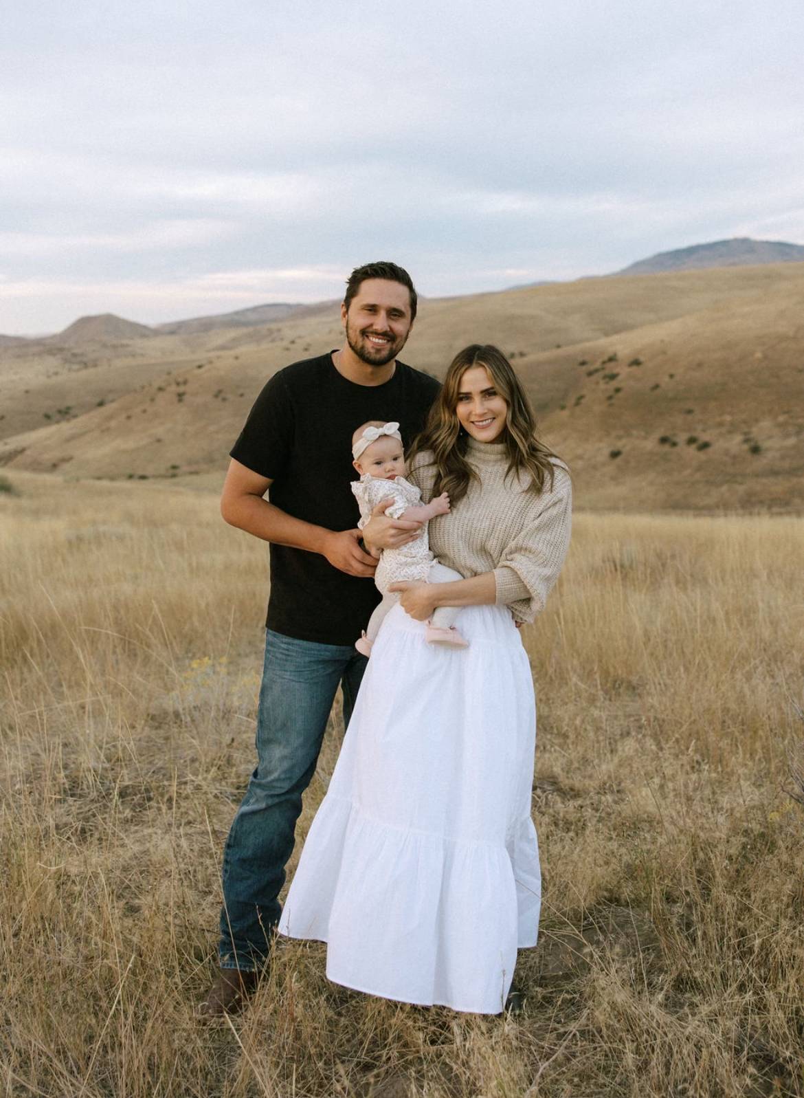 Kelly Salutregui, RN, BSN, poses in a field with her family.