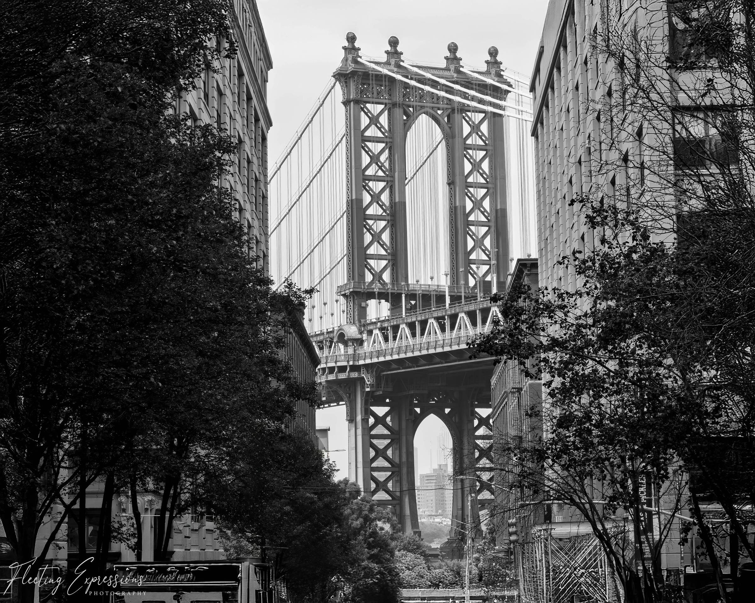 Manhattan Bridge between buildings