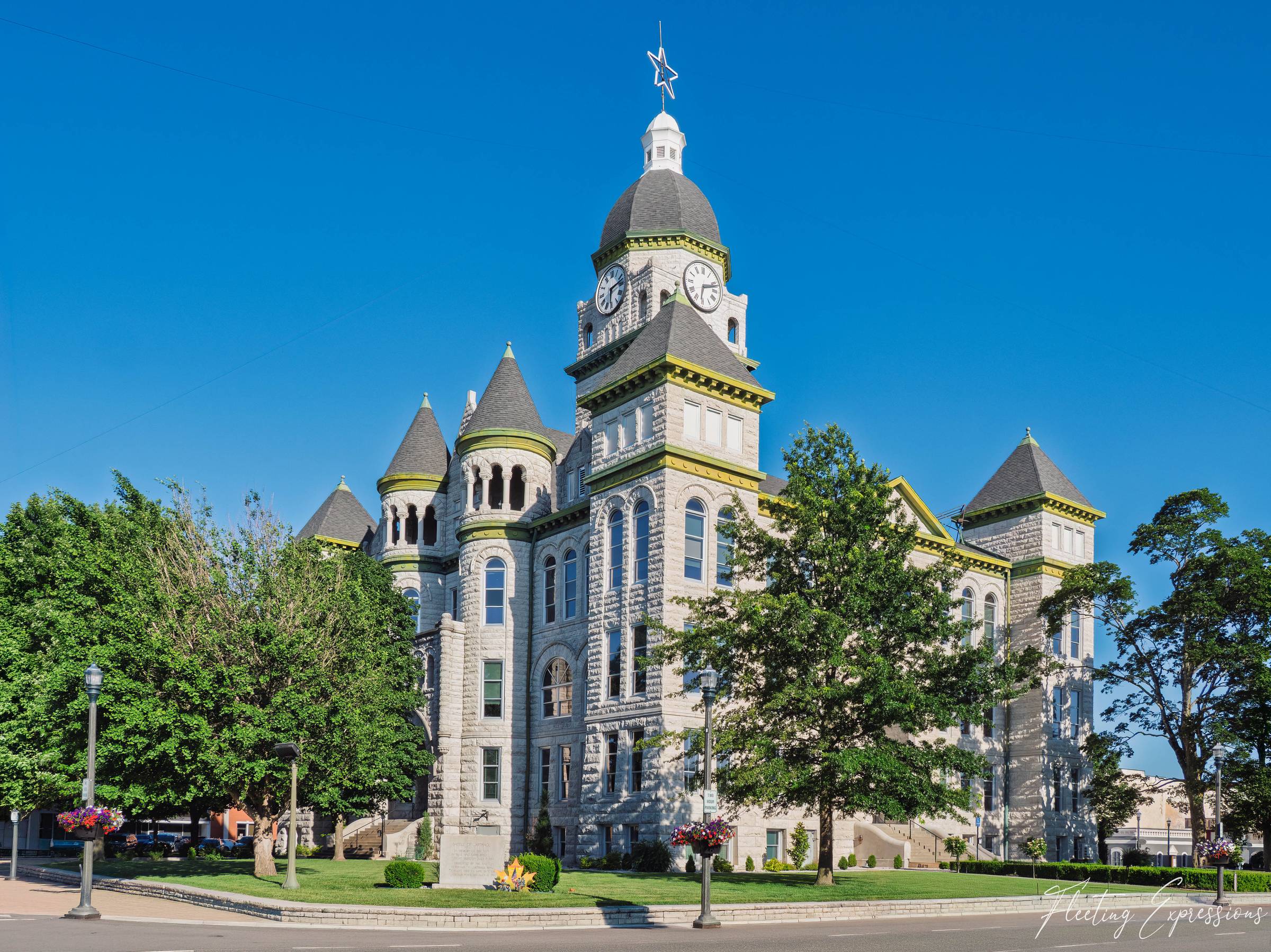 Jasper County Courthouse in Carthage, MO, stone building with turrets, clock tower, and star on top