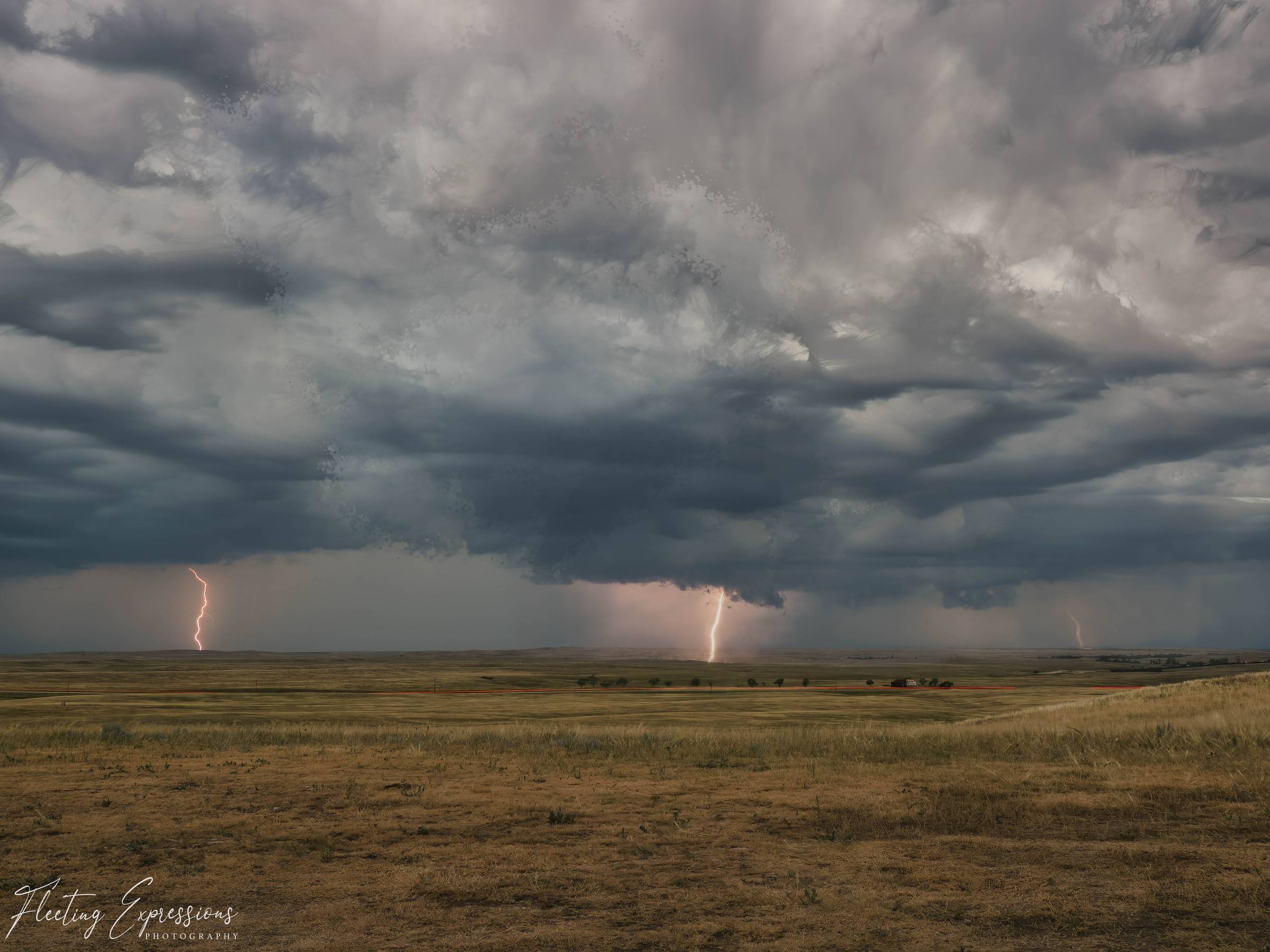 Multiple lightning bolts striking the prairie beneath dark storm clouds, with a farmstead and tree line on the horizon. 