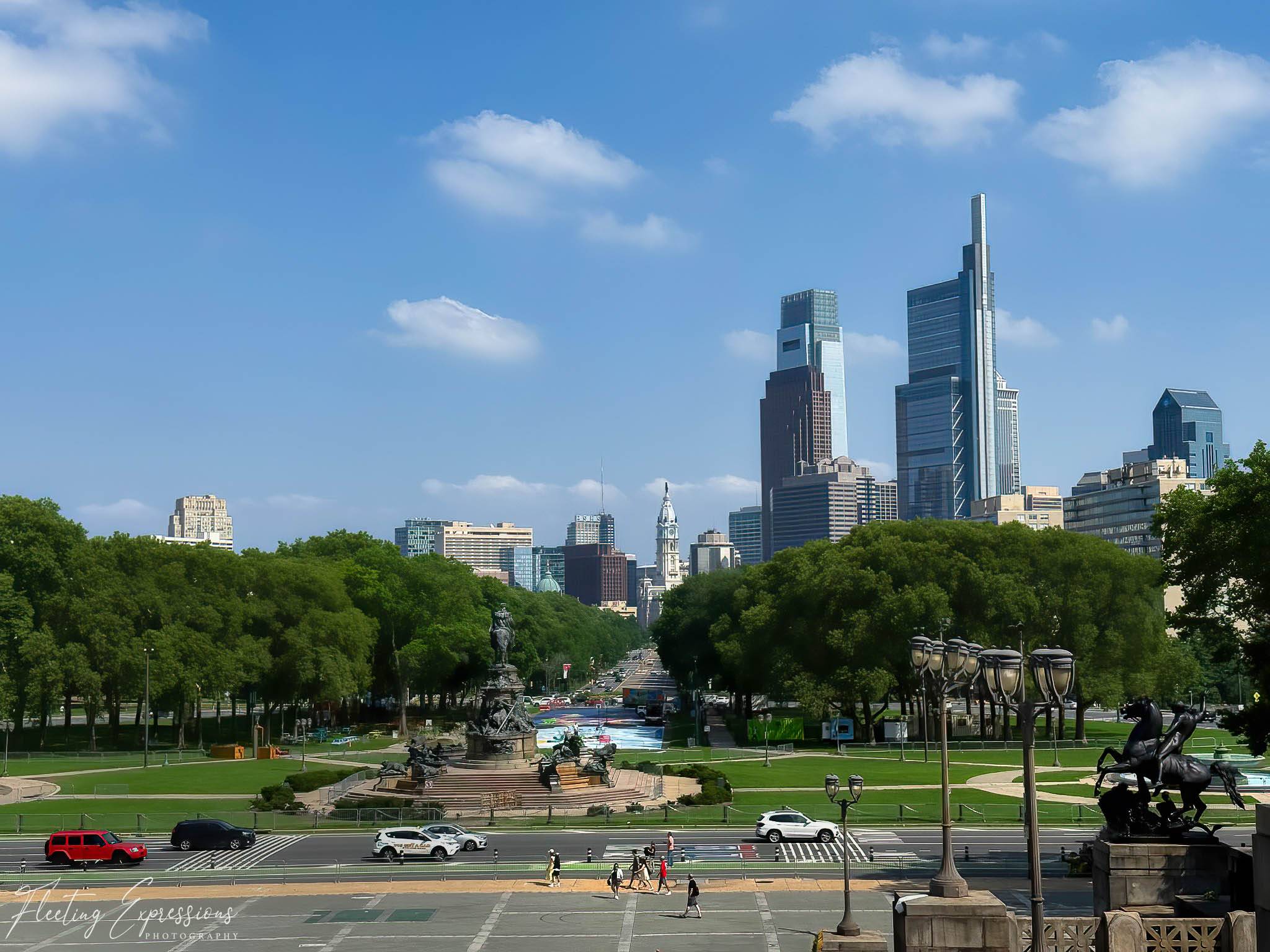 landscape view of the Philadelphia skyline with tall buildings in the far distance 