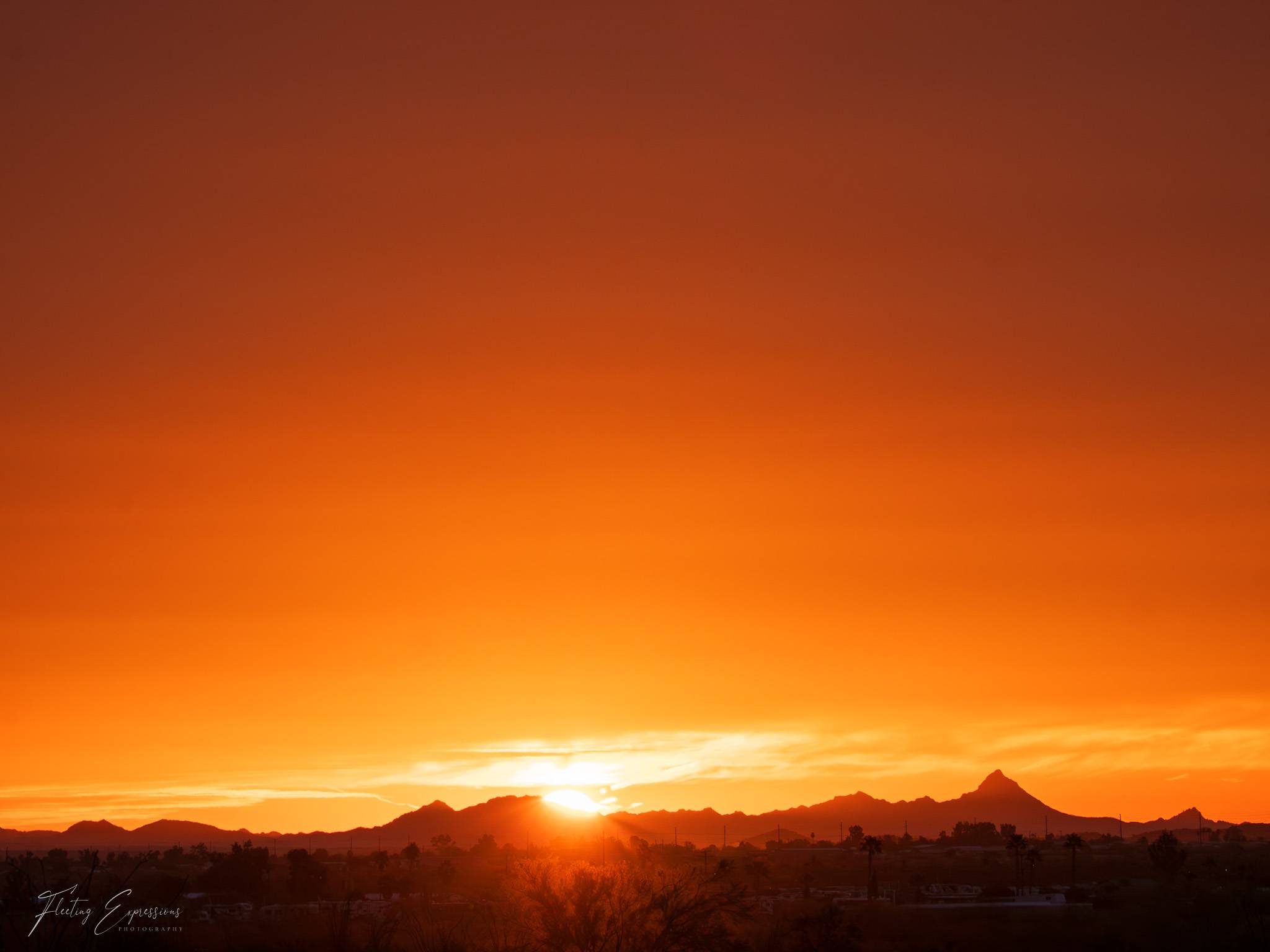 Golden sunrise over desert mountains
