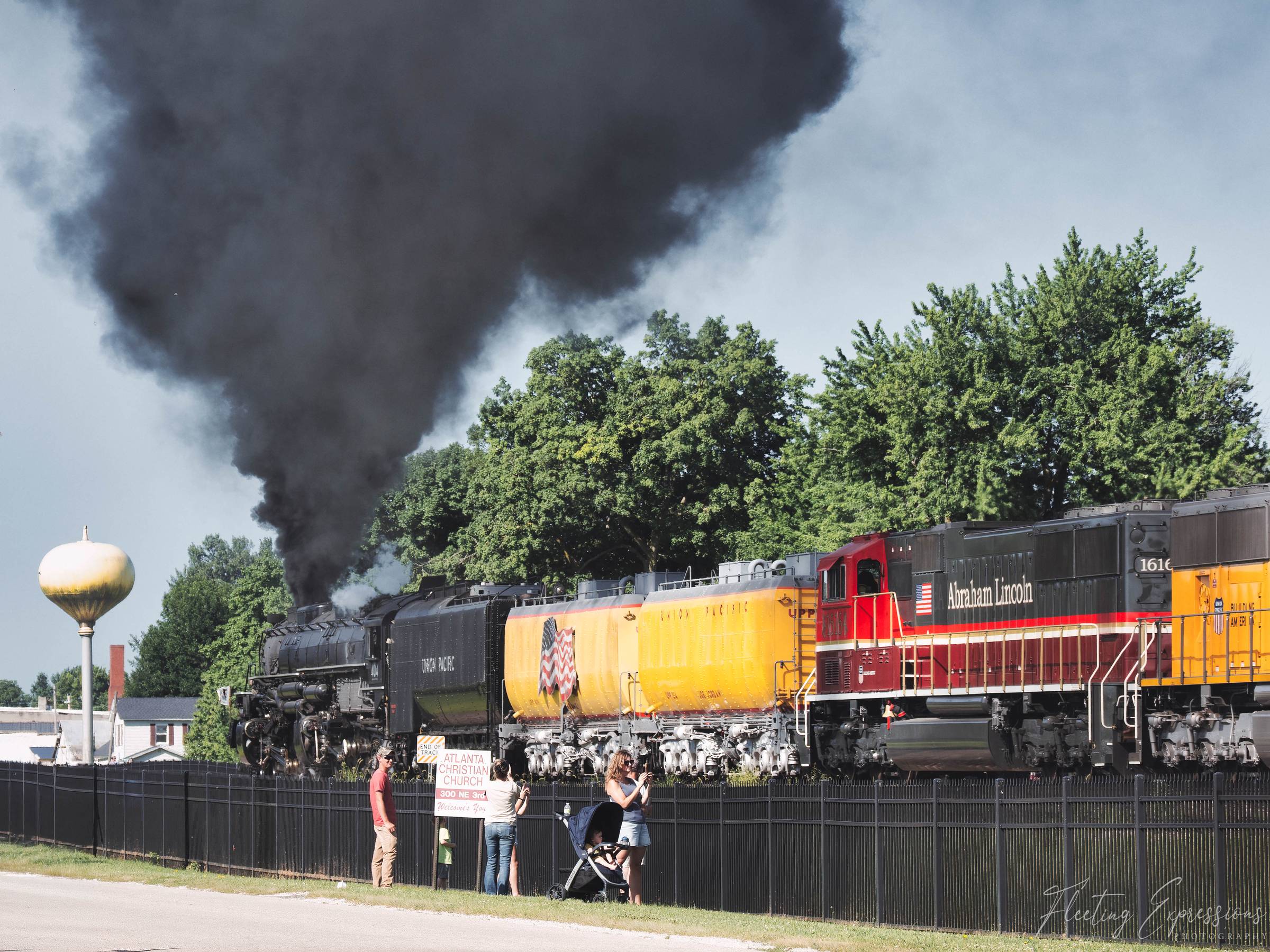 Black smoke billows from Union Pacific's Big Boy steam locomotive as it rolls past onlookers near Atlanta, Illinois.