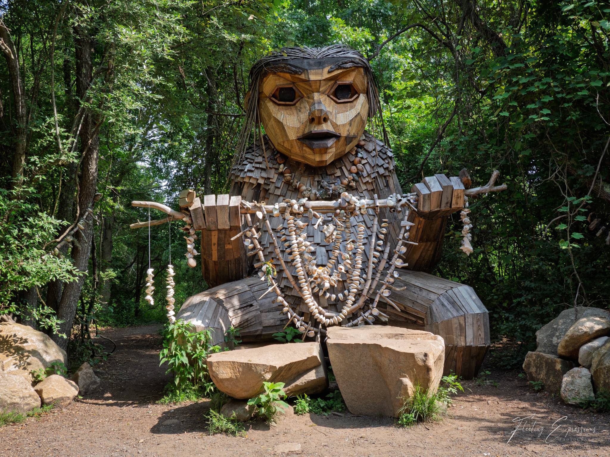 Wooden art sculpture of a troll in the woods