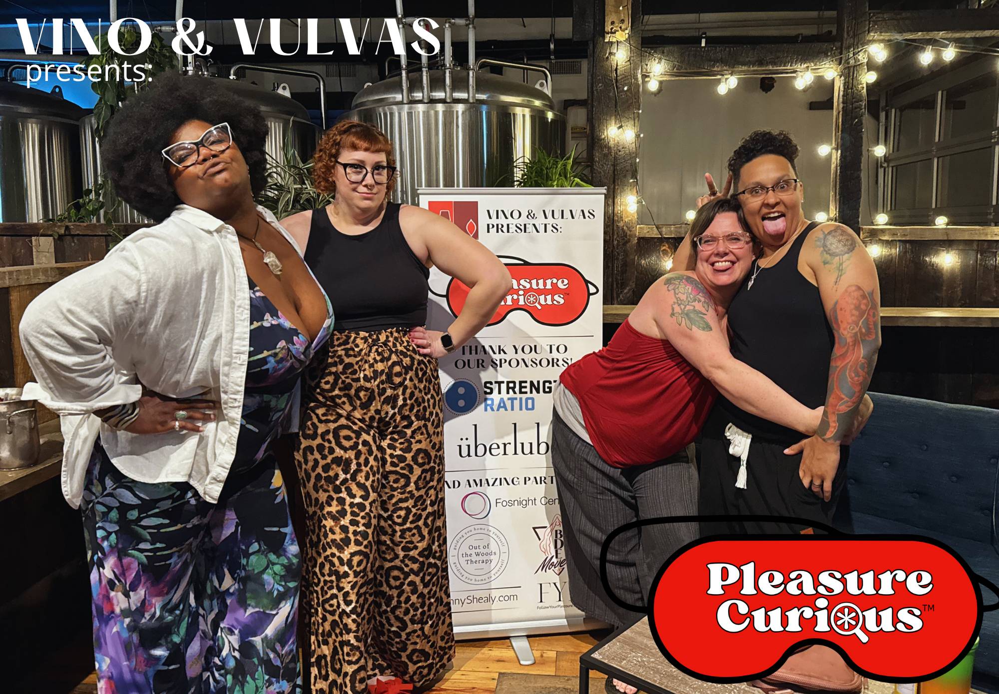 The four panelists posing in the RAD brewing area with a pleasure curious sign between them and the Vino & Vulvas and Pleasure Curious logos