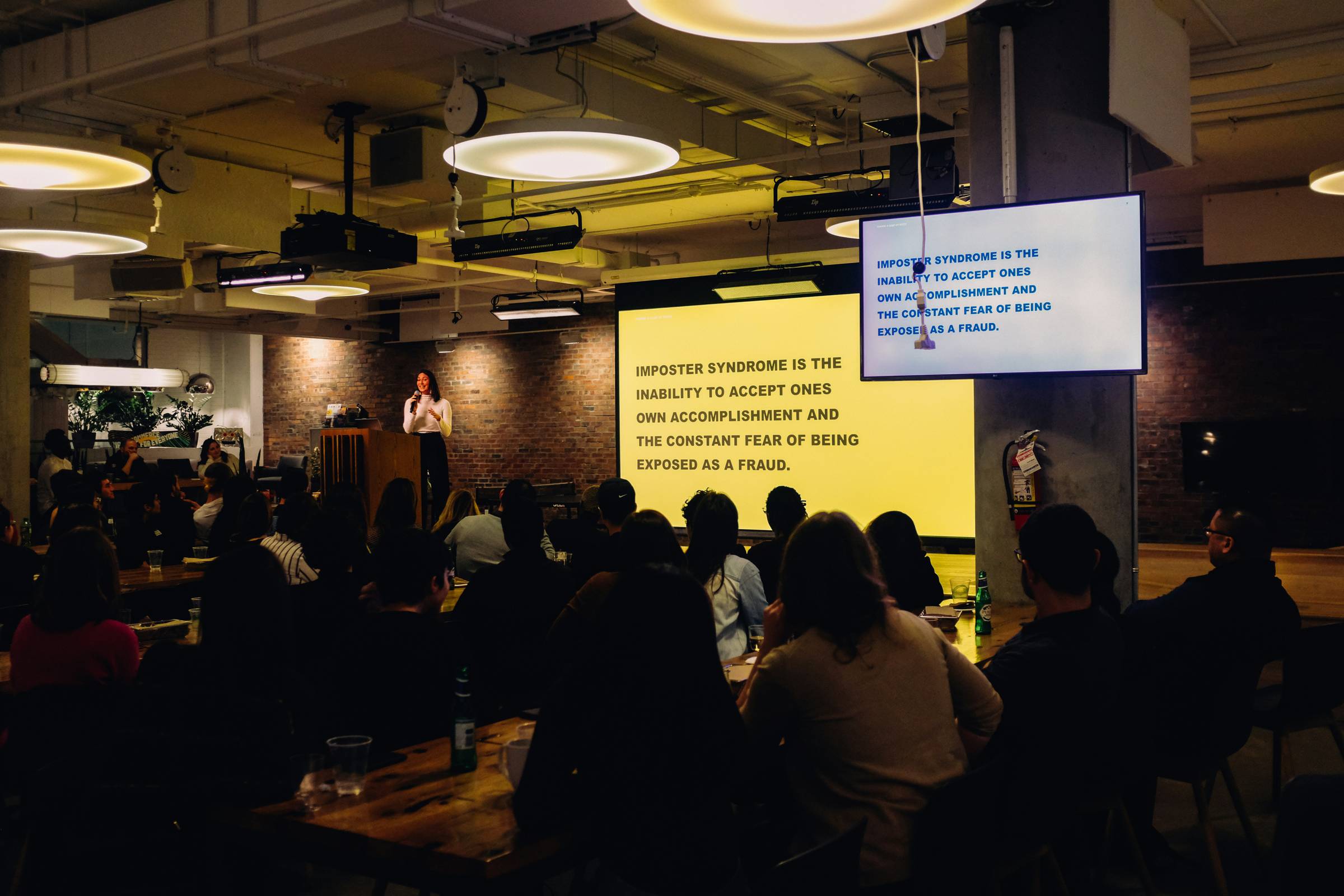 Author giving a signature speech about imposter syndrome