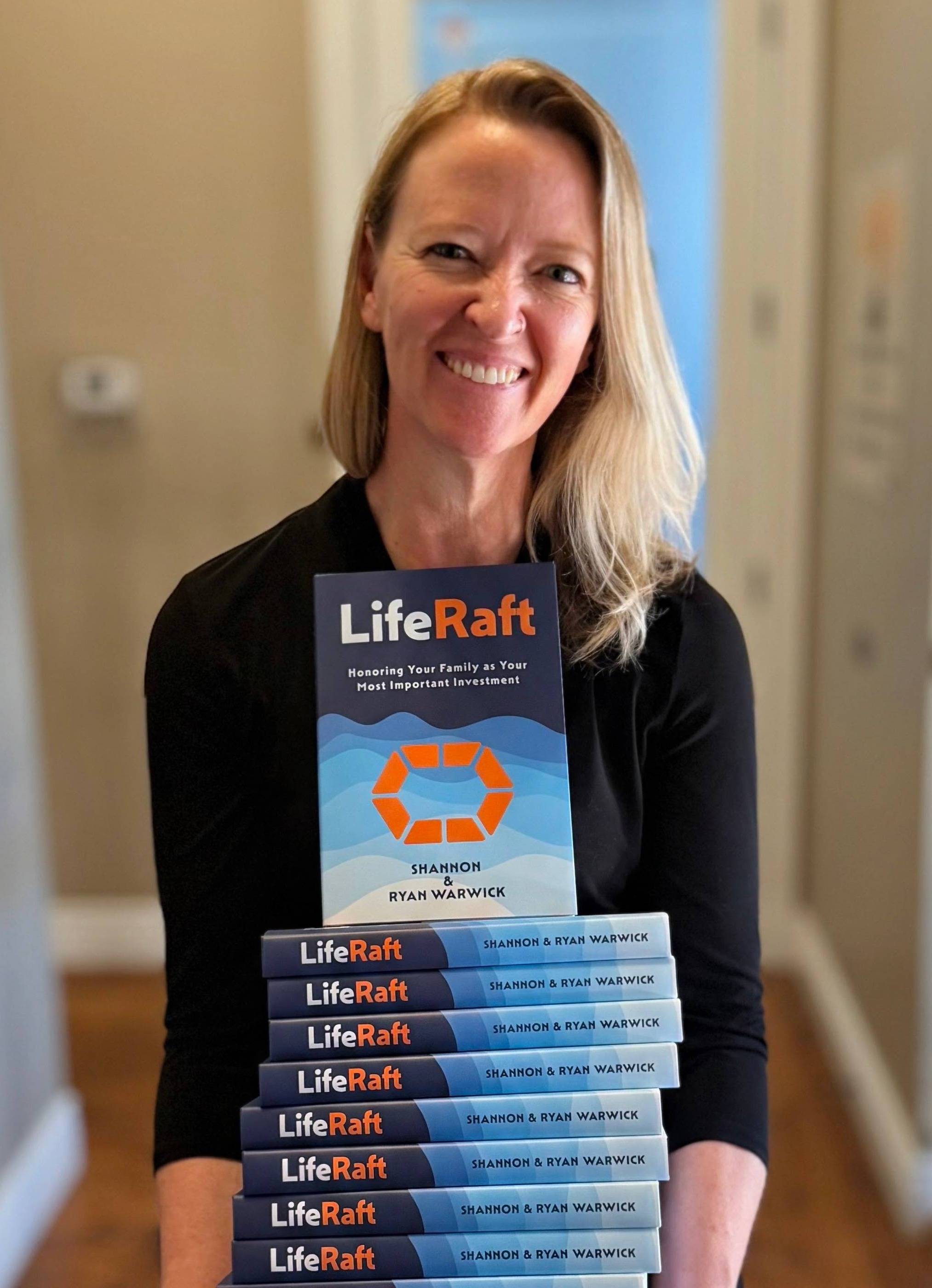 Heather Goetter with a stack of LifeRaft books