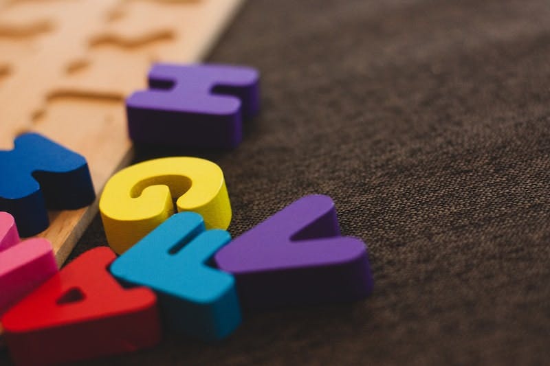 alphabet learning toy on gray apparel