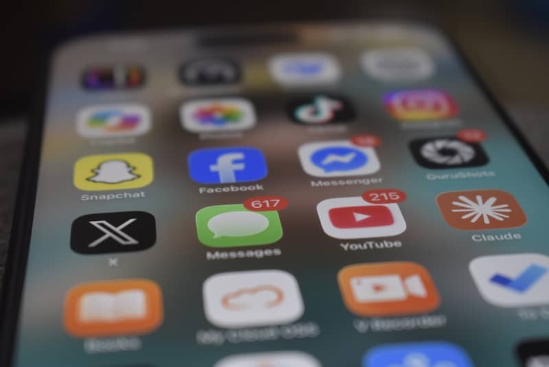 A smartphone screen displaying various social media and messaging app icons with notification badges