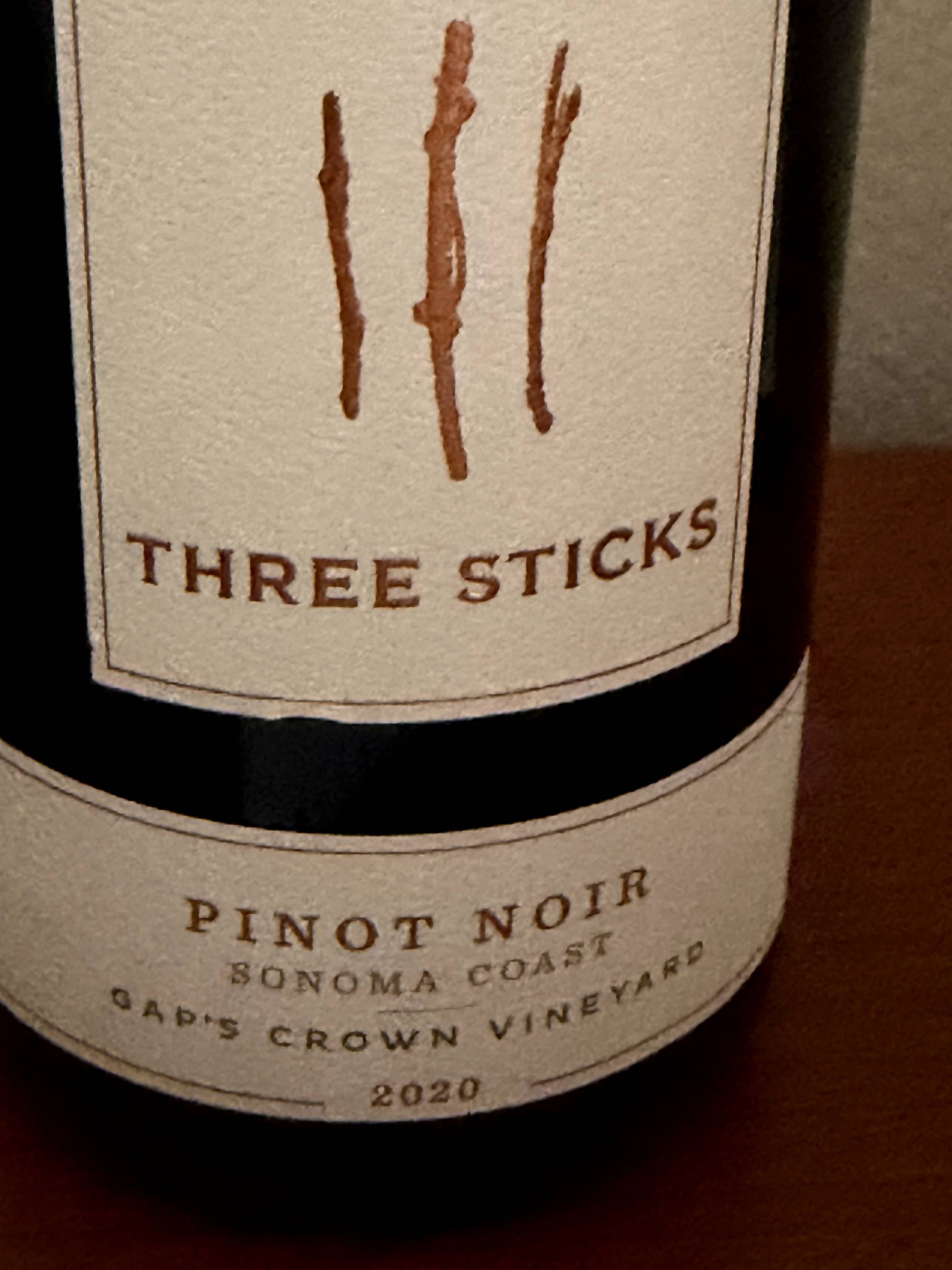 Front label of a 2020 Three Sticks Pinot Noir, Sonoma Coast, Gap's Crown Vineyard. Three brown hand-drawn sticks sit above the winery name on a cream label.