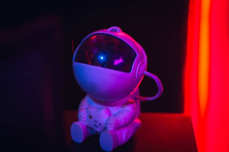 A small astronaut toy with a glowing blue light.