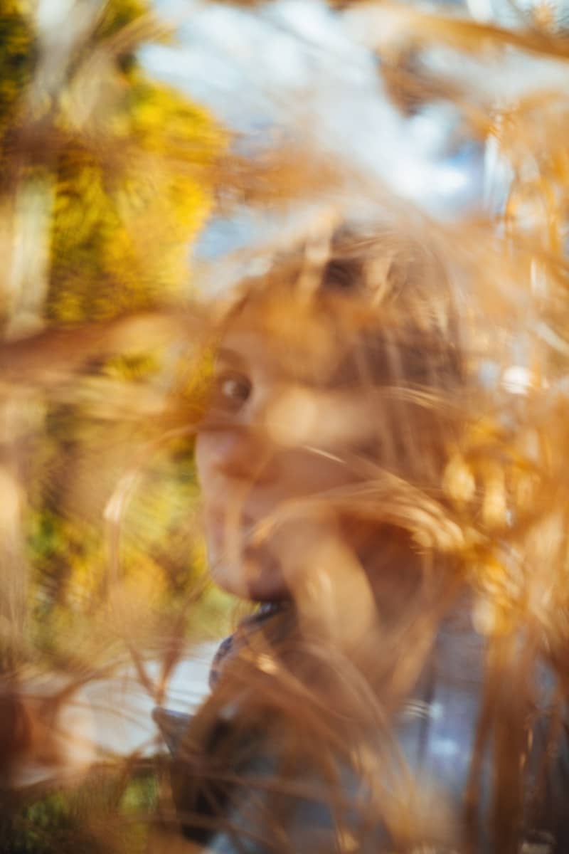 A blurry photo of a woman looking through a window