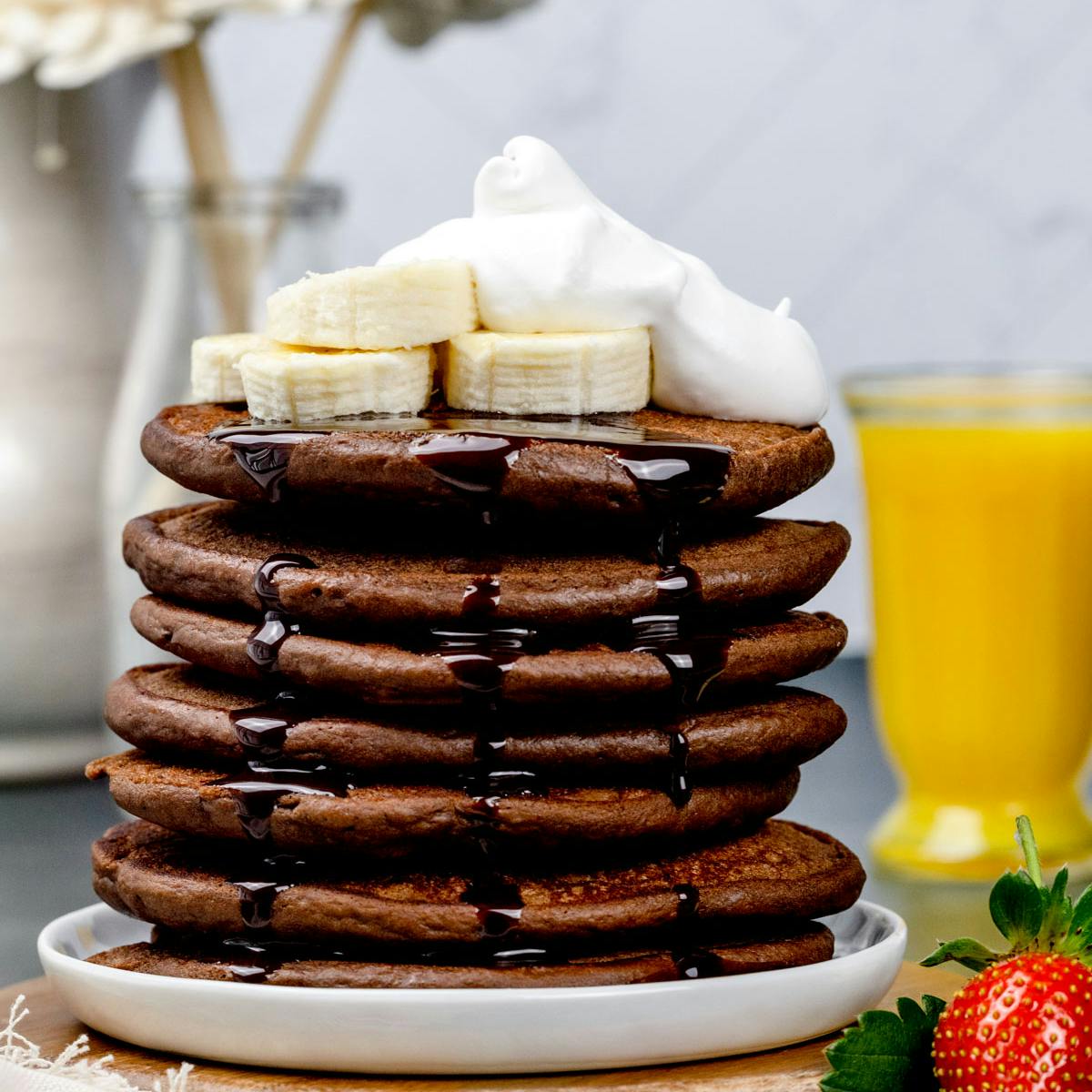 A stack of chocolate protein pancakes on a white plate. 