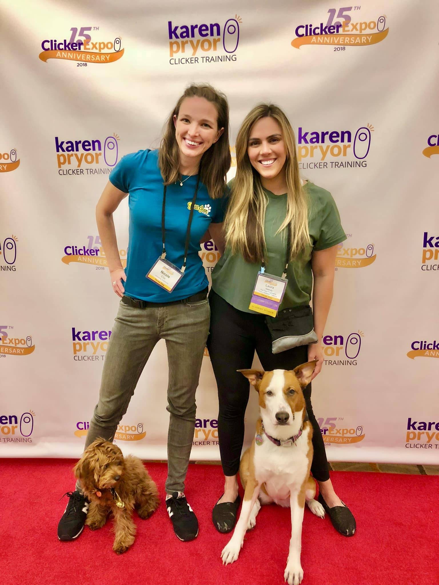 Nicole Ellis standing with her dog, Maggie, and Laura Nativo with her dog, Delilah, smiling