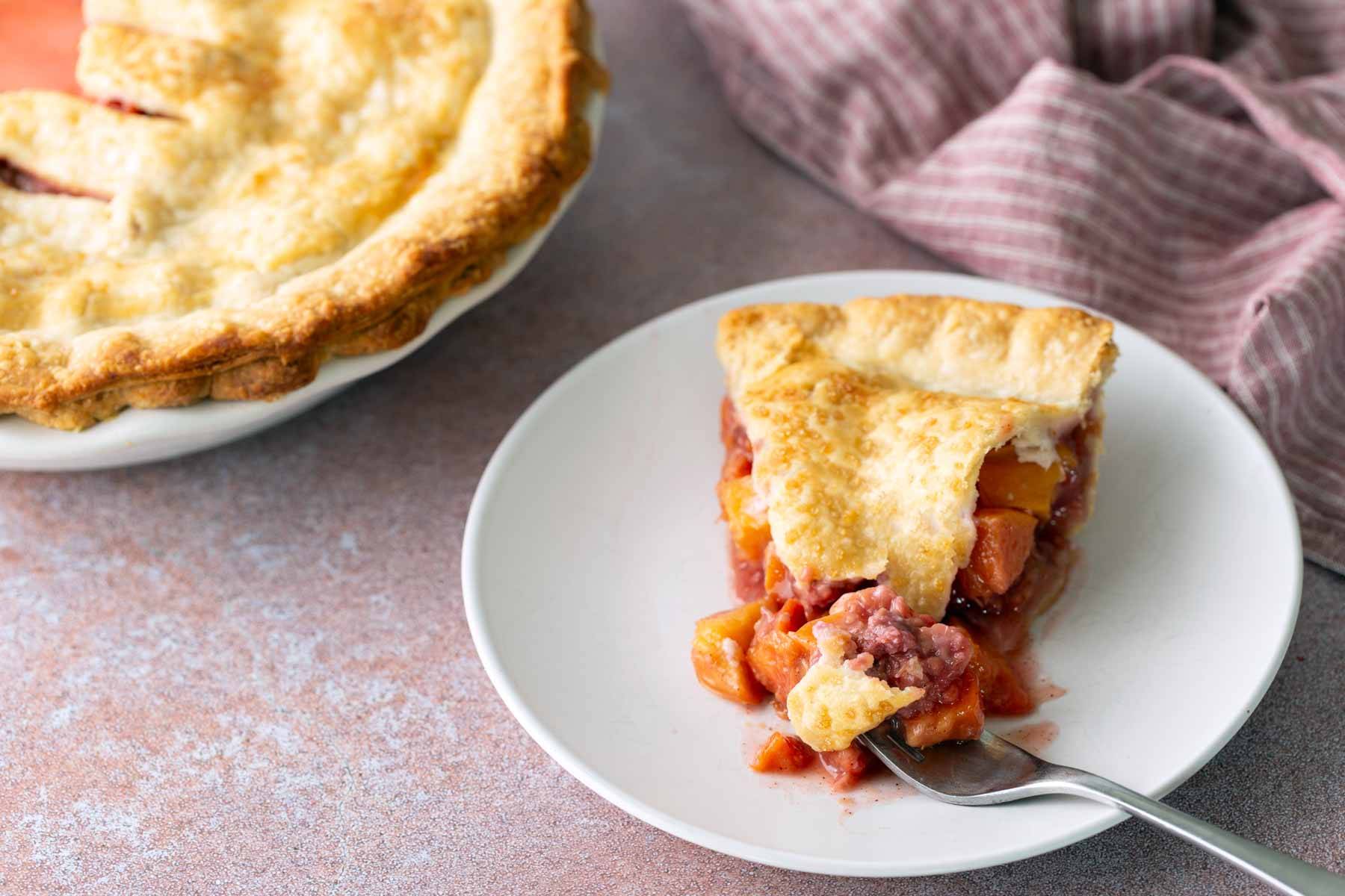 A slice of fruit pie on a plate.