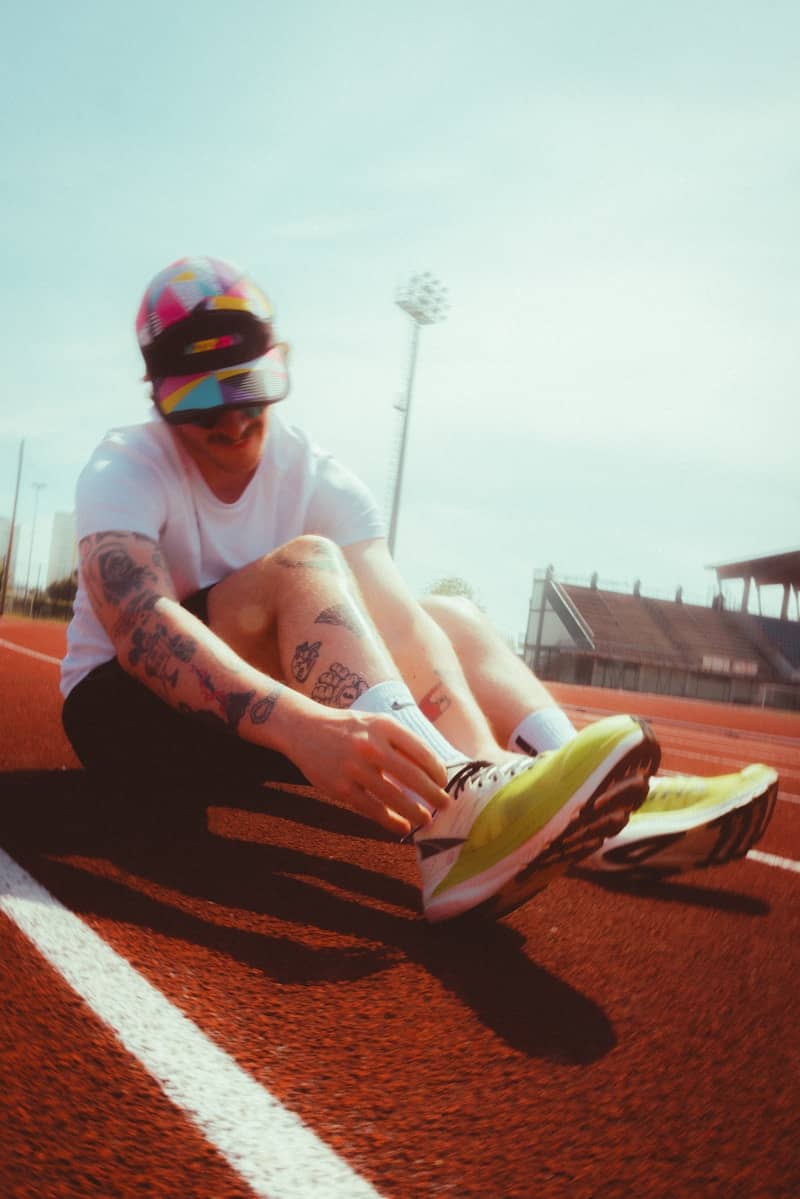Runner tying shoes on a track