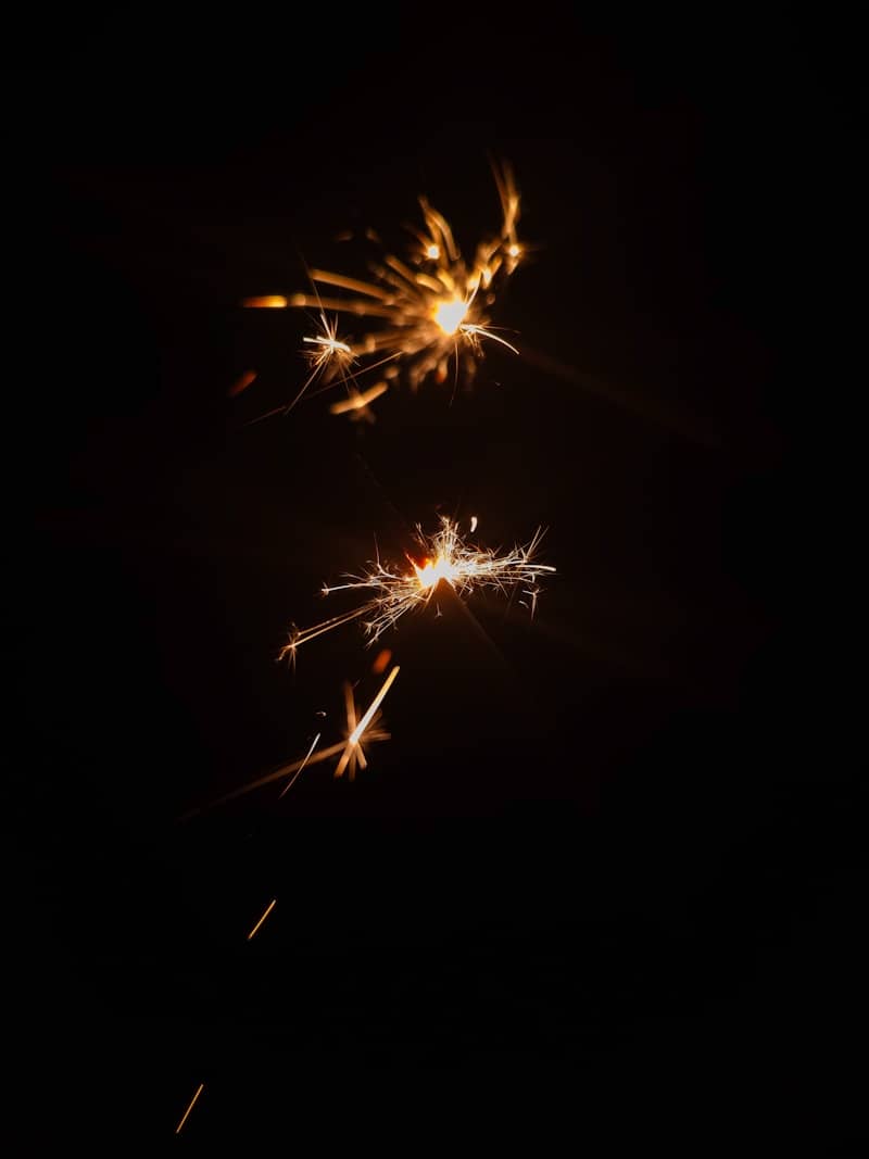 Sparklers illuminate the darkness with bright sparks.