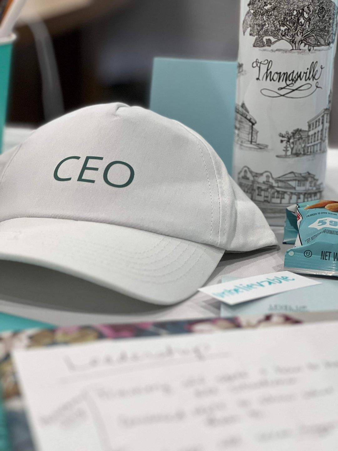 Wendy Batten with shop owners at a CEO Time retreat, everyone wearing a CEO hat